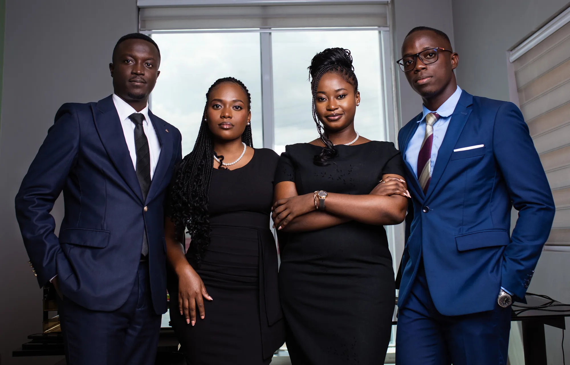 Four PETROSOL professionals standing together in corporate attire