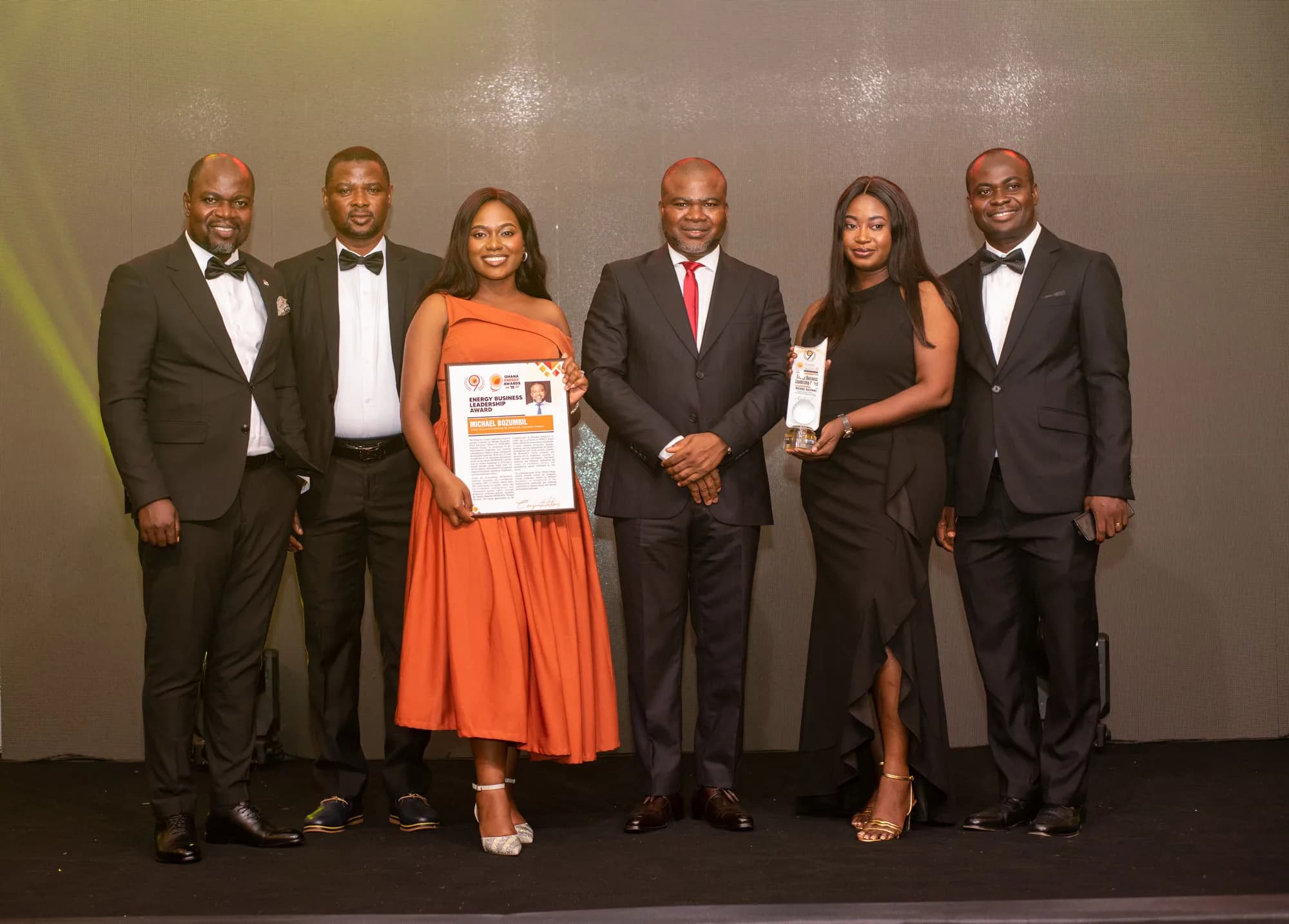 PETROSOL leaders on stage with the Energy Business Leadership Award citation and trophy