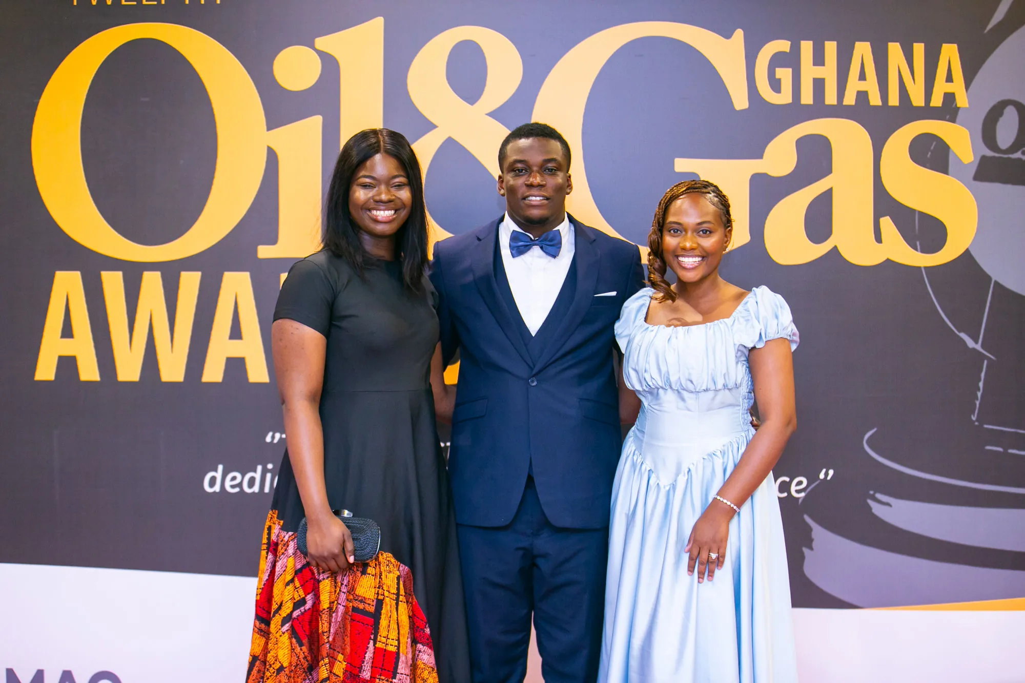 Three PETROSOL colleagues at the Twelfth Ghana Oil and Gas Awards backdrop